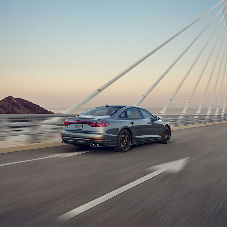 Three quarter rear view of the Audi S8 accelerating.