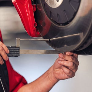 Technician measuring brake rotor