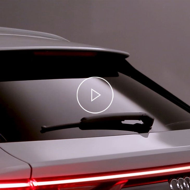  Close-up photo on the rear windshield wiper of an Audi vehicle. 