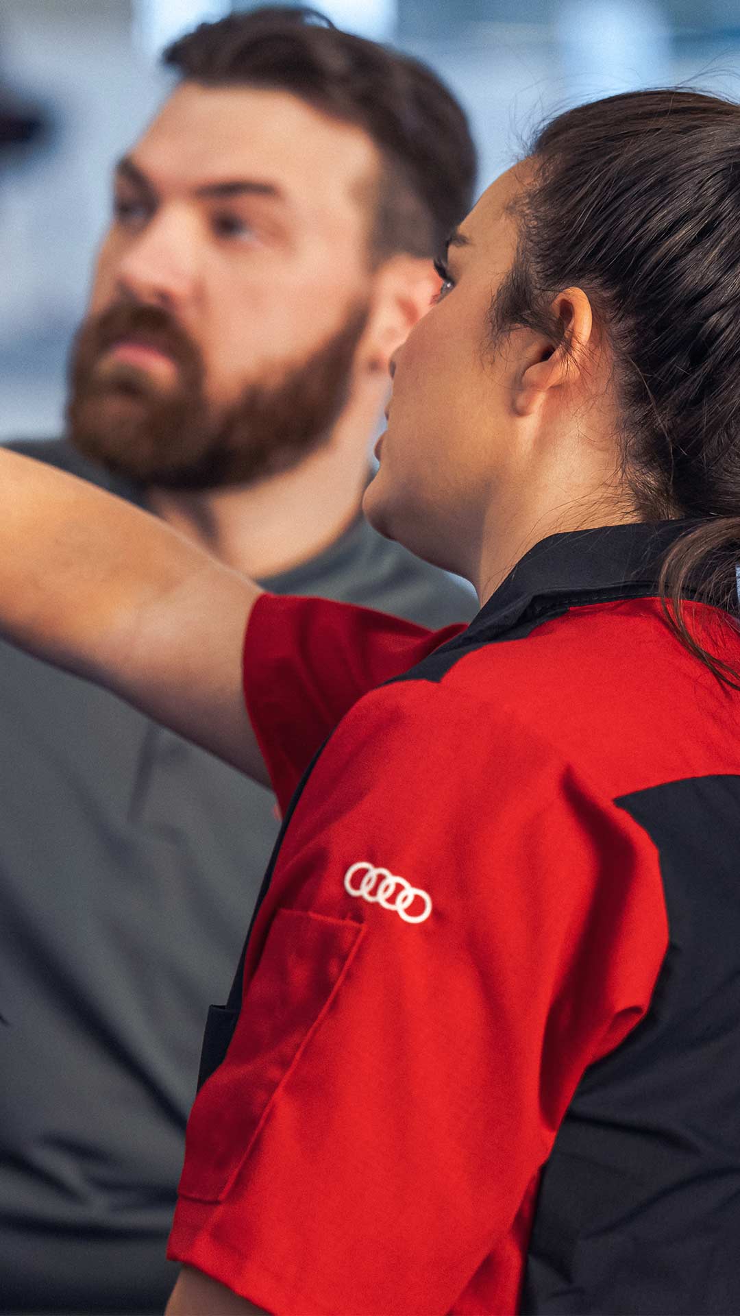 Service technician servicing a tire with another technician.