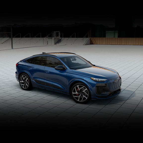 Three-quarter front view of the Audi SQ6 Sportback e-tron parked.