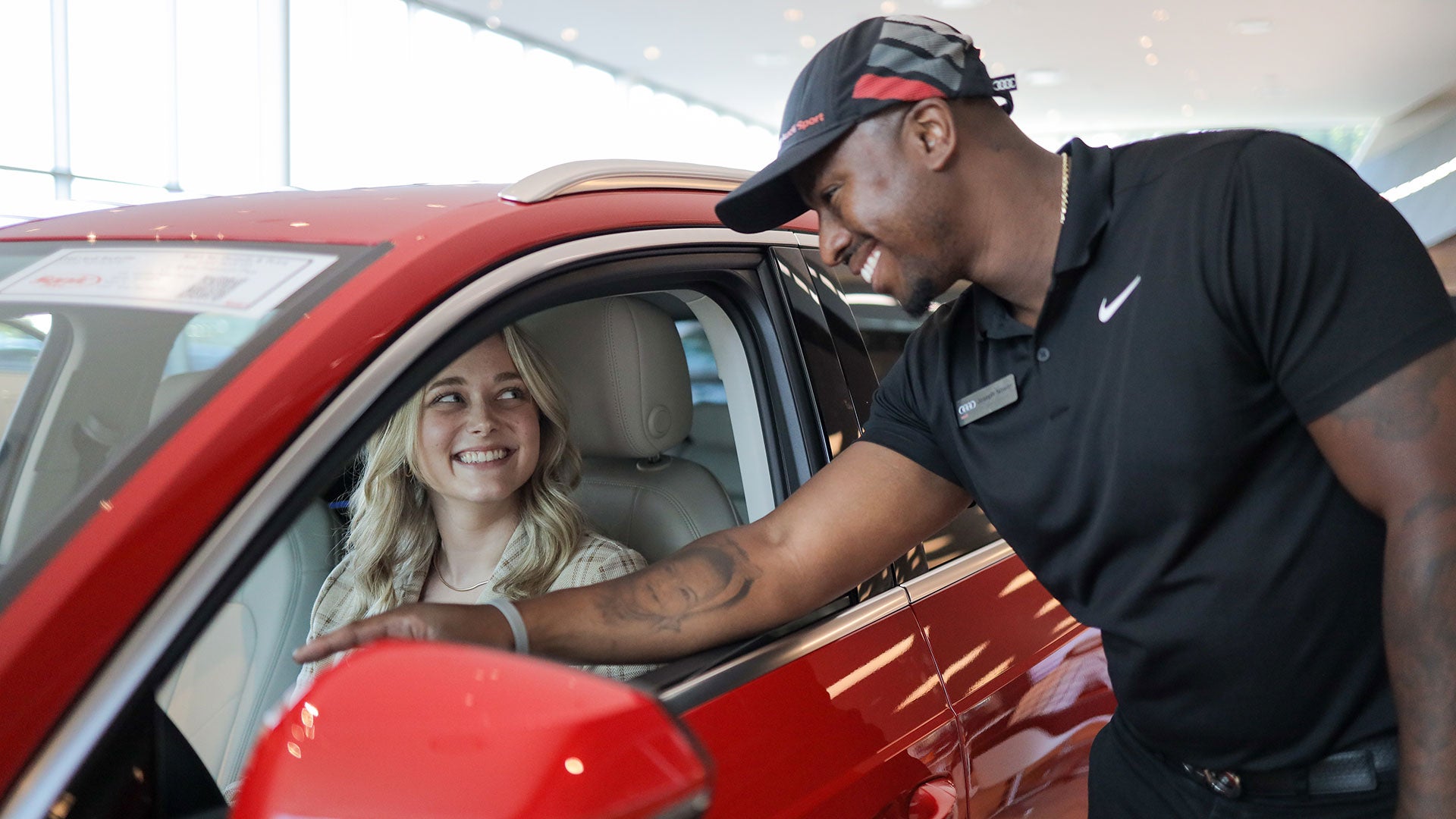 Audi Sale Specialist explaining vehicle features to a customer.