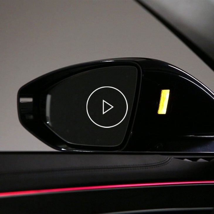  Close-up photo of the side mirror displaying side assist feature in an Audi.
