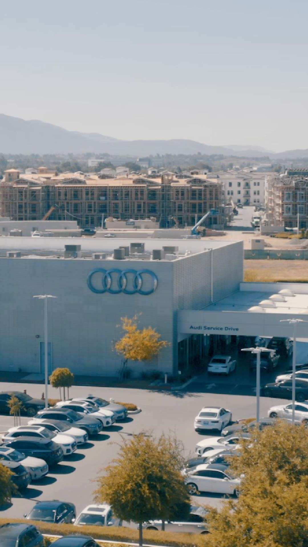Two people chatting with each other across the charging station.