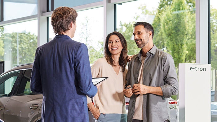 An Audi service advisor and customers