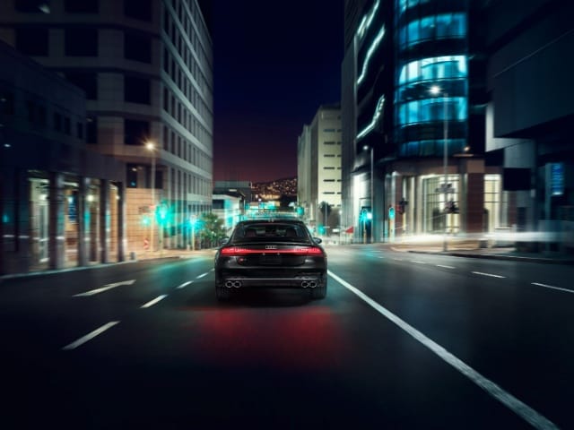 Rear view of 2025 Audi S7 in night city lights