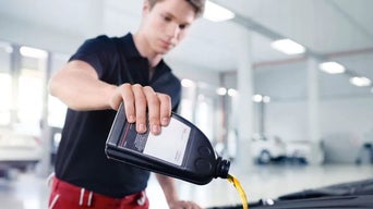 Service technician serving vehicle.