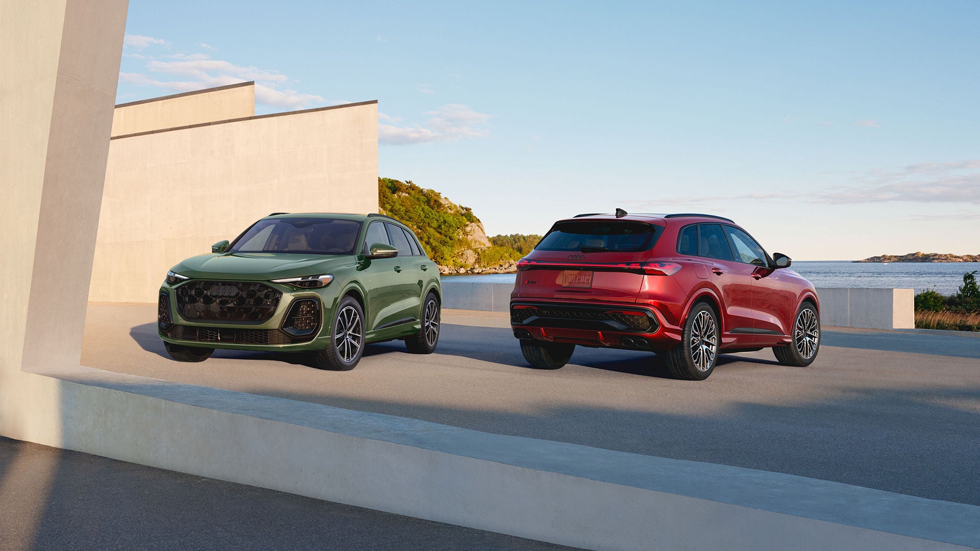 2026 Audi Q5 and Sportback parked next to each other in a parking lot so you can see front and the back.
