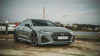 Three-quarter front view of parked Audi vehicle. 