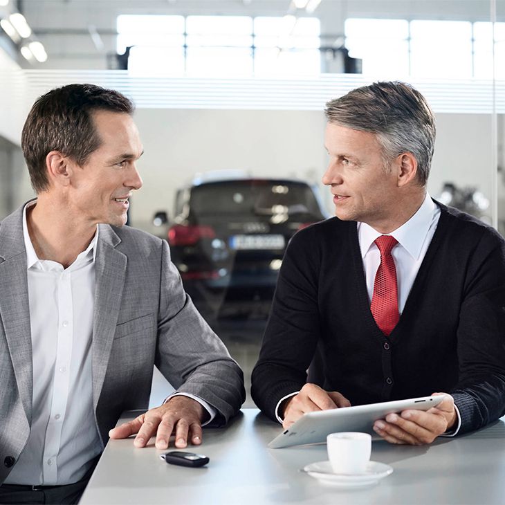 Two people discussing lease plans.