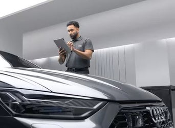 Service technician servicing vehicle.