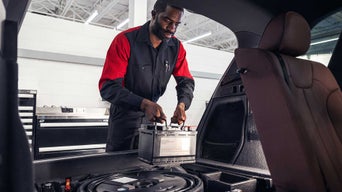 Audi technician replacing car battery