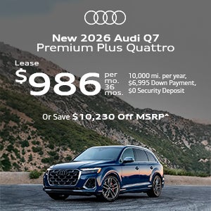 Side view of an Audi Q7 driving.