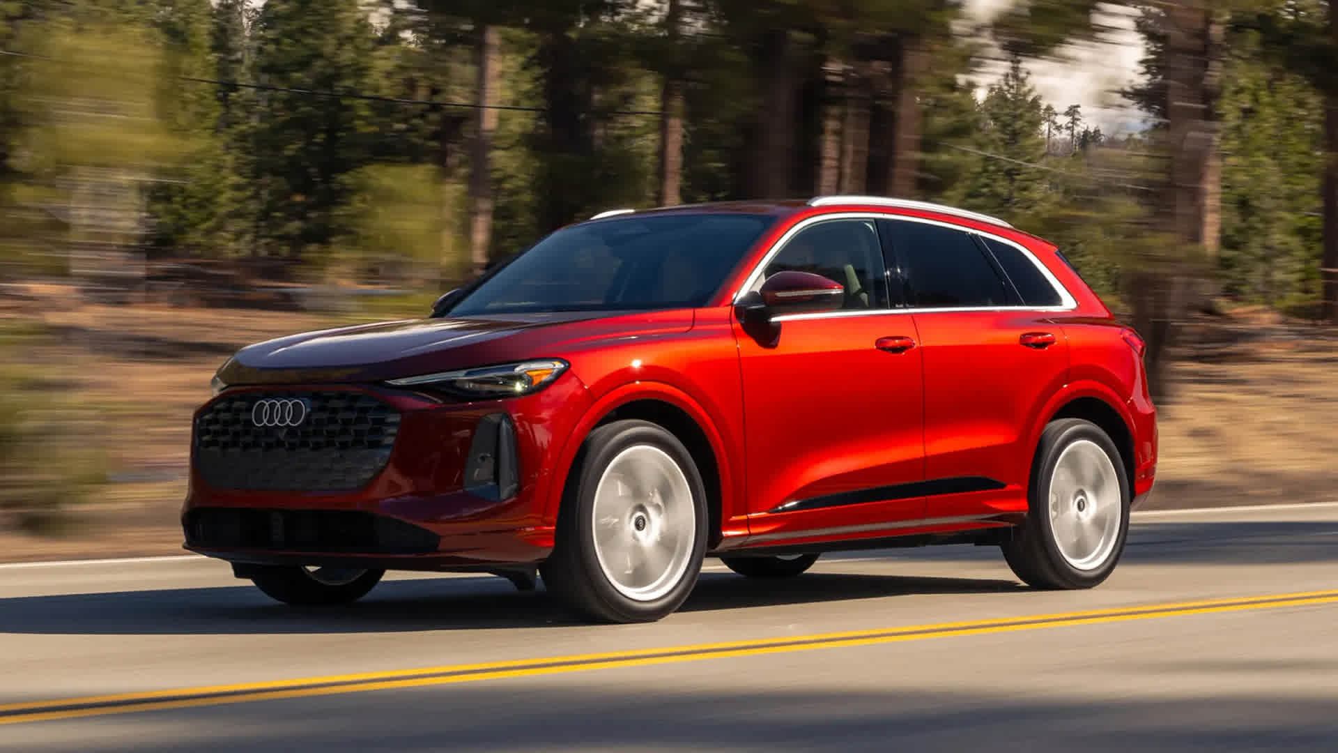 Right side profile view of an Audi Q5 accelerating.