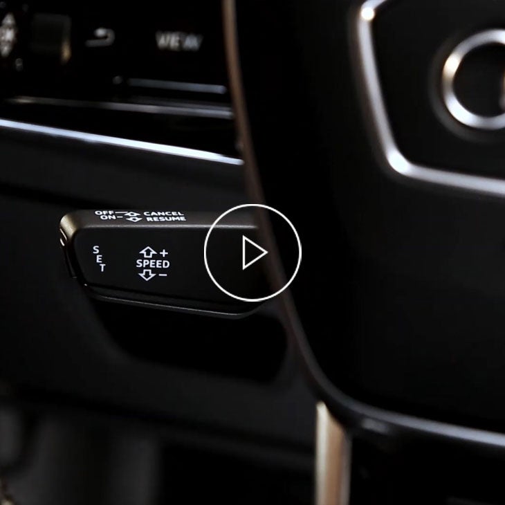Close-up photo of the cruise control lever inside an Audi vehicle. 