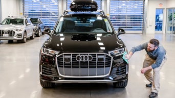 Service advisor wiping down car