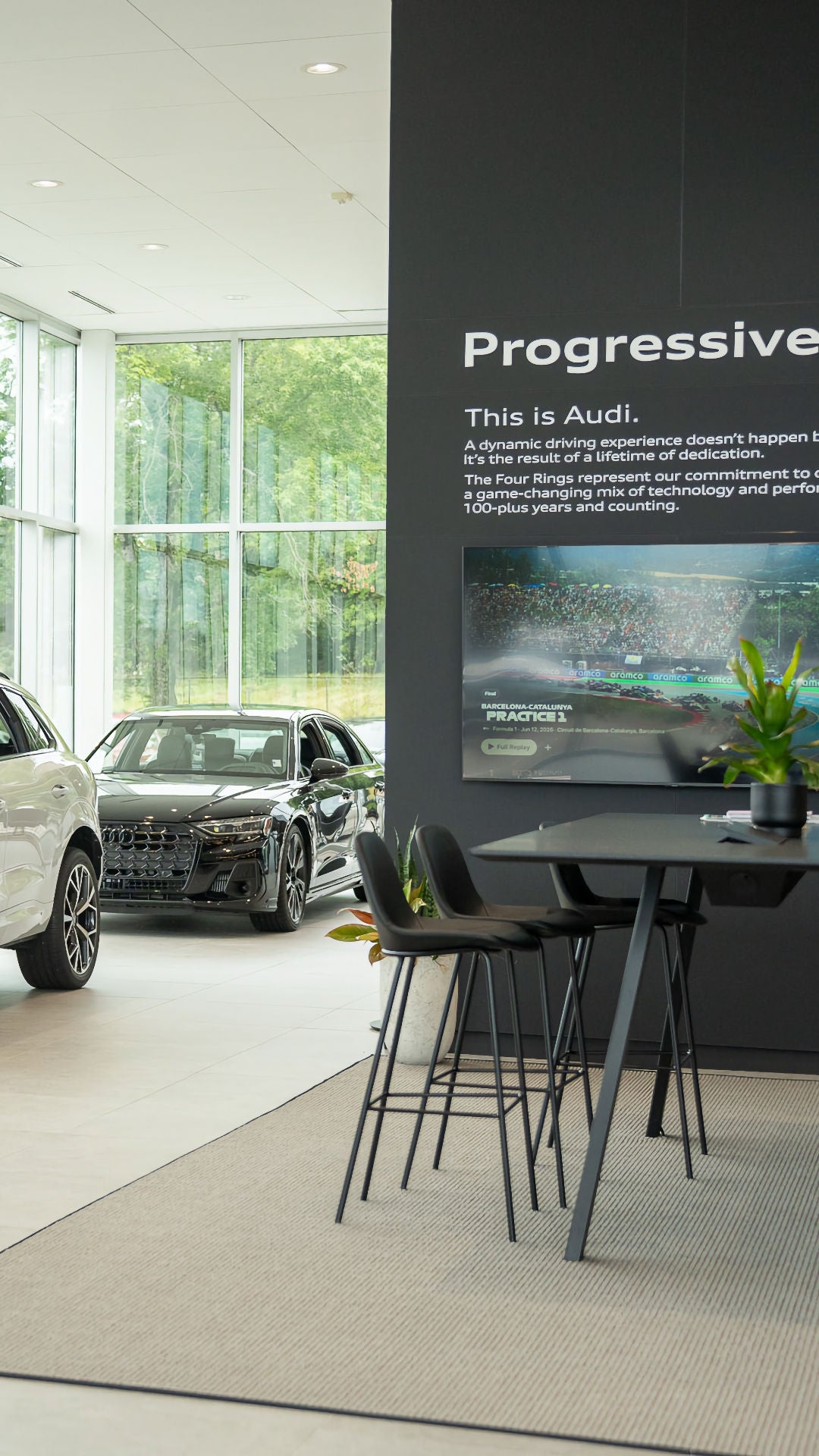 Front profile view of an Audi vehicle parked in the showroom.