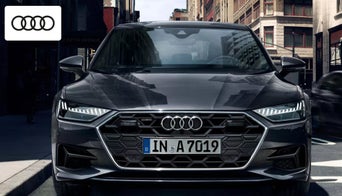 2025 Audi A7 parked outside the Audi Dayton dealership, showcasing its modern luxury design 
