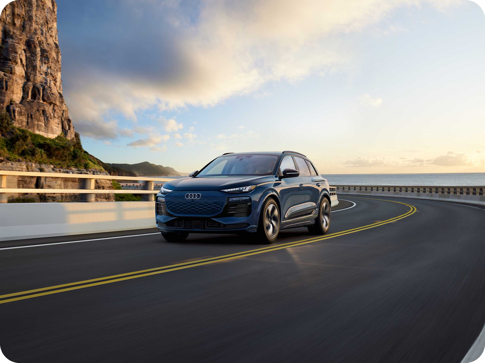 Audi Q6 e-tron — mid-size electric SUV driving.