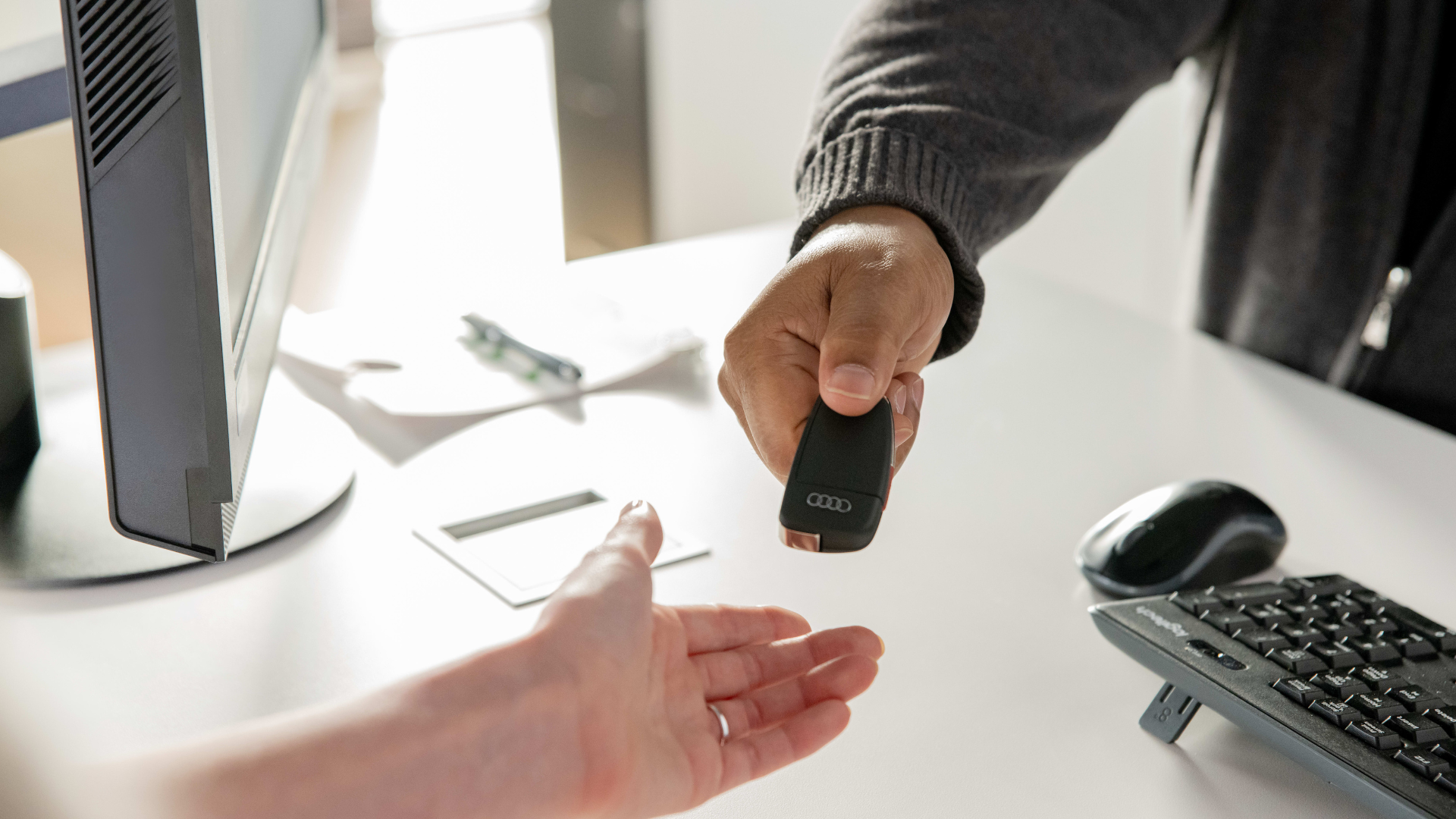 Handing over an Audi car key.