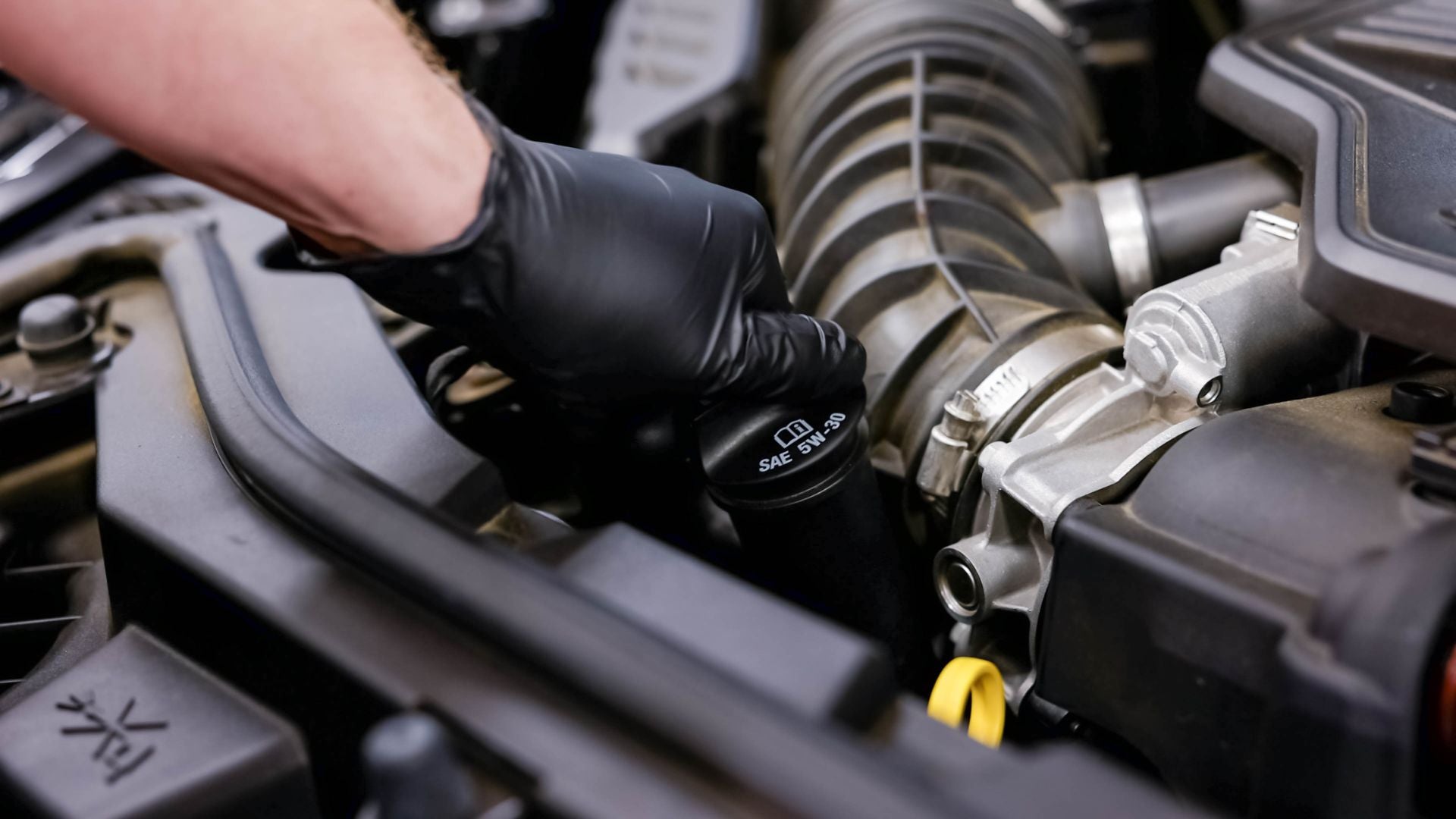 Audi service technician servicing a vehicle.