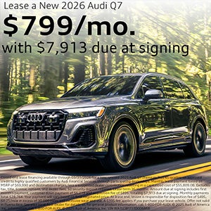 Side view of an Audi driving.