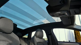 View of the 2026 Audi A6 e-tron's panoramic glass roof from the interior of the vehicle.