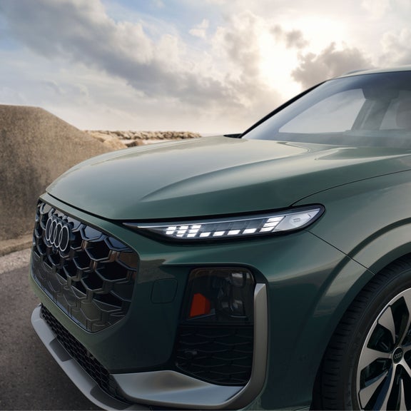 Gros plan sur le phare avant de l'Audi Q3, montrant les feux de jour.