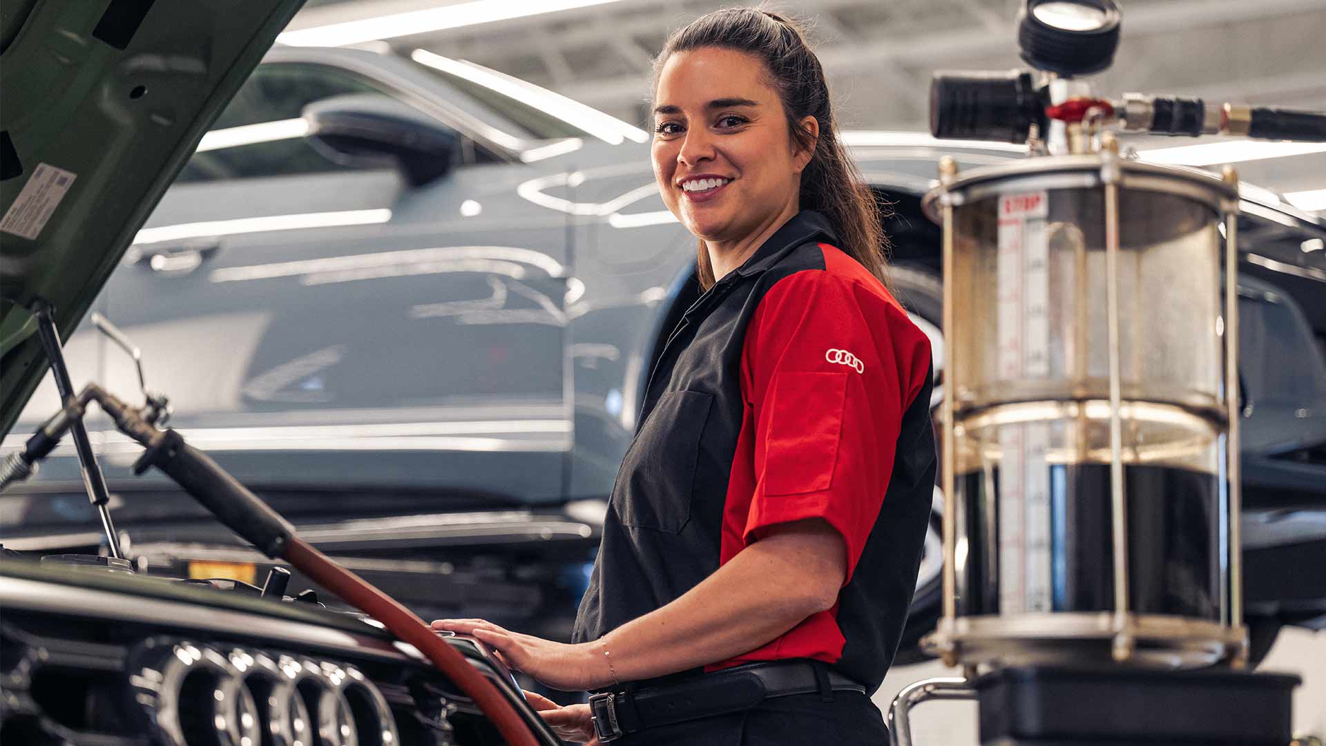 Service technician servicing a vehicle.