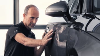 Service technician servicing vehicle.