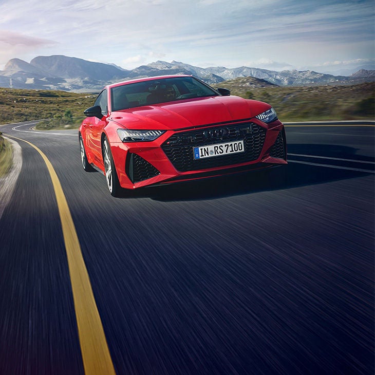 Three-quarter front view of the Audi RS 7 accelerating.