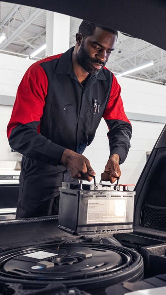 Audi technician inspecting vehicle. 