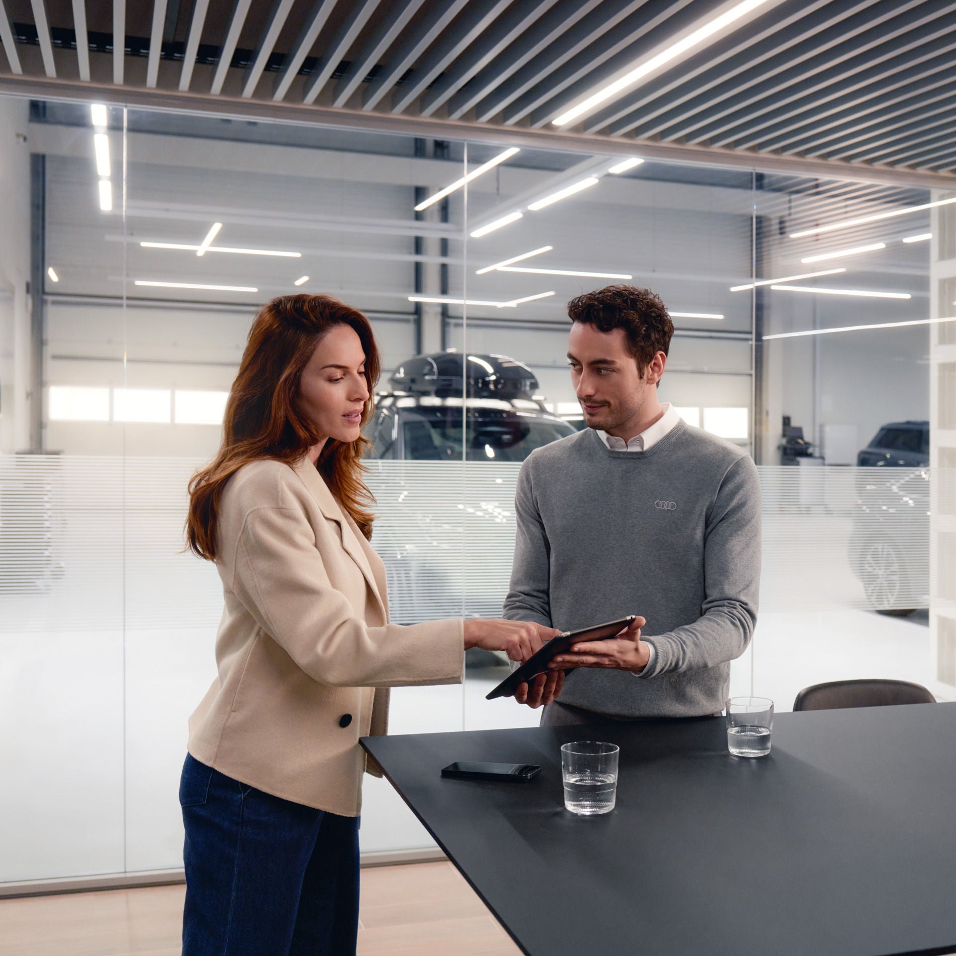 An Audi vehicle owner getting assistance from an Audi dealership representative.