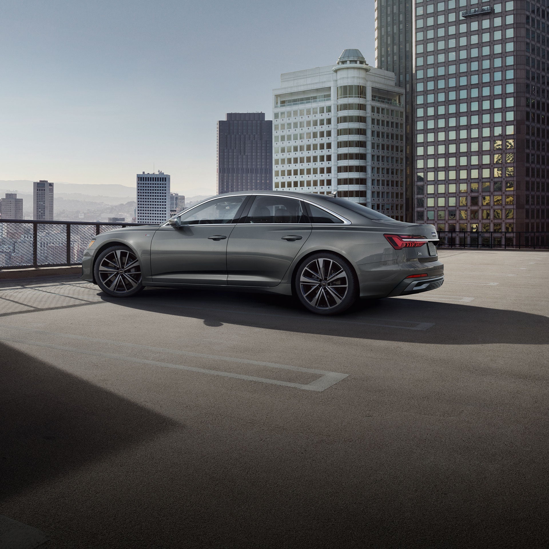 Three-quarter side view of the Audi A6 Sedan parked on a city street.