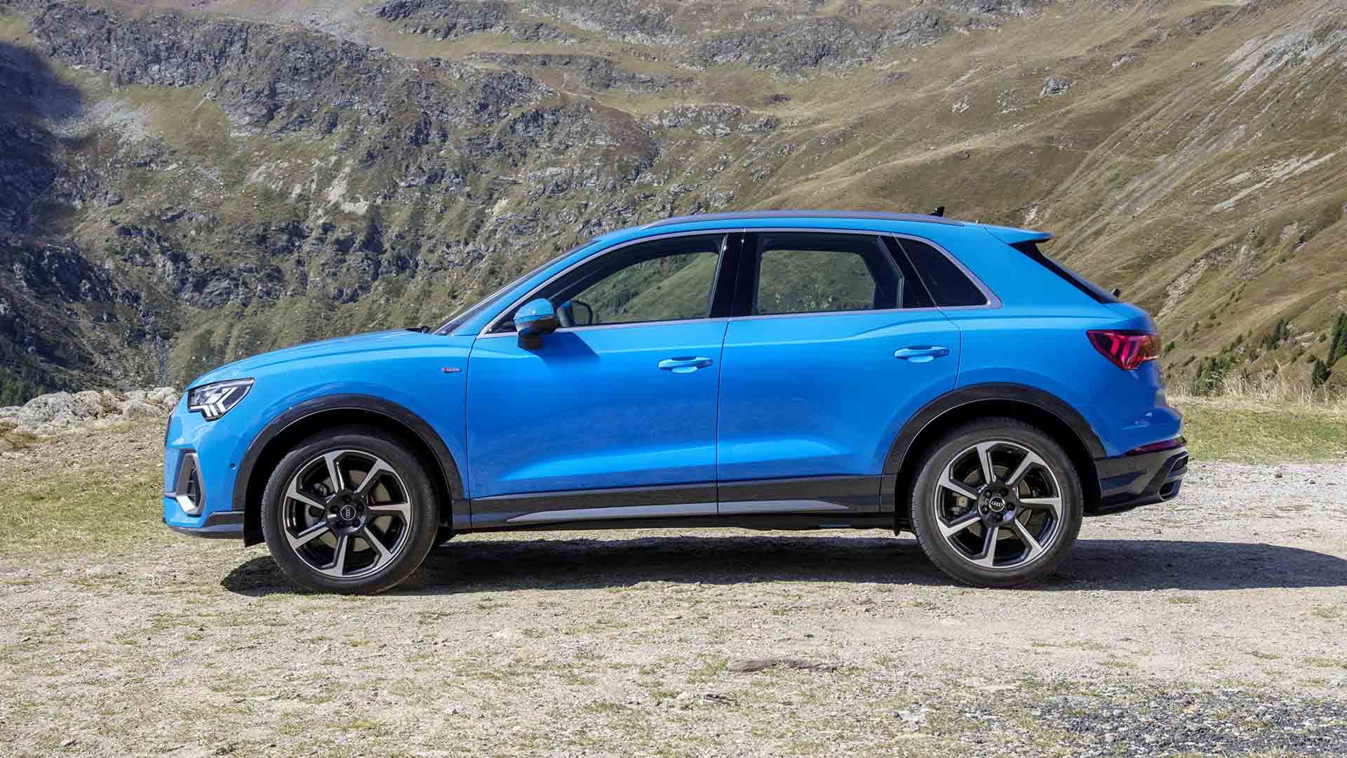 side profile view of four audi sedan vehicles parked.
