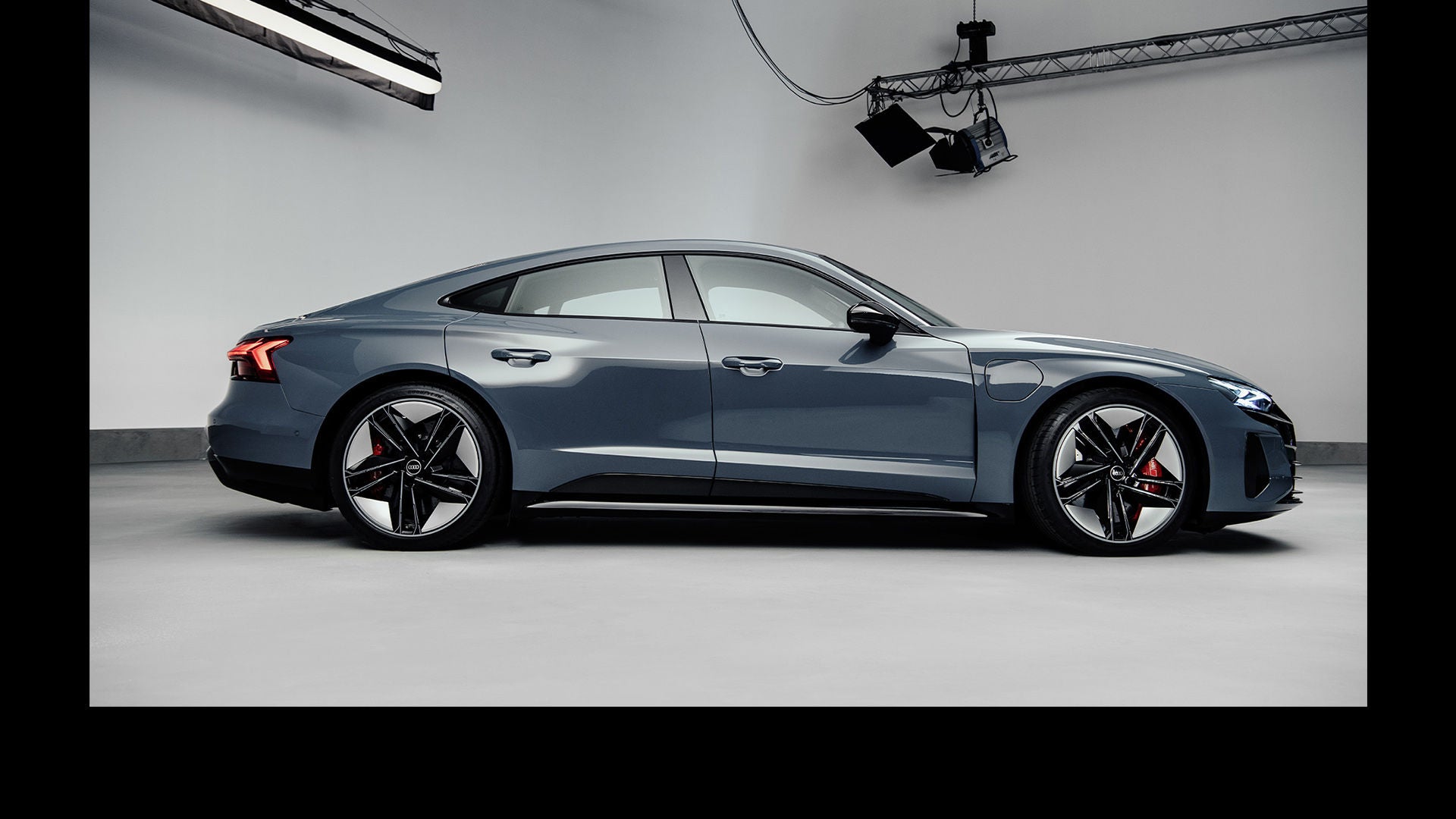 Side profile of the Audi RS e-tron GT in a photo studio.