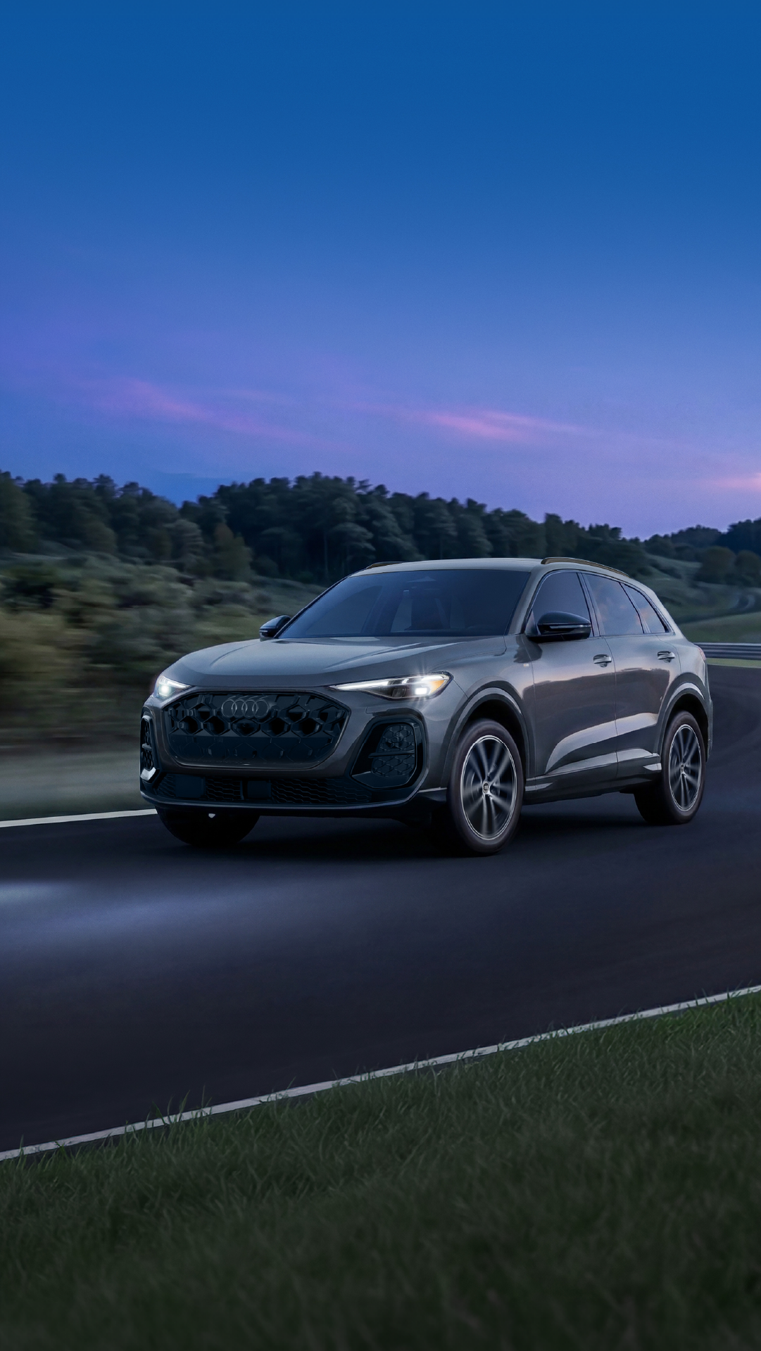 2026 Audi grey Q5 driving on road in blue hour image