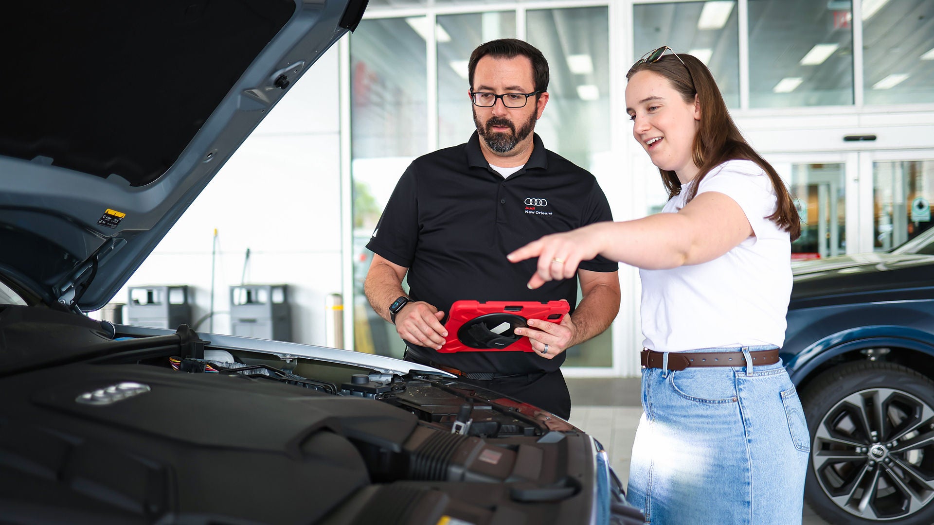 Audi service technician servicing a vehicle.