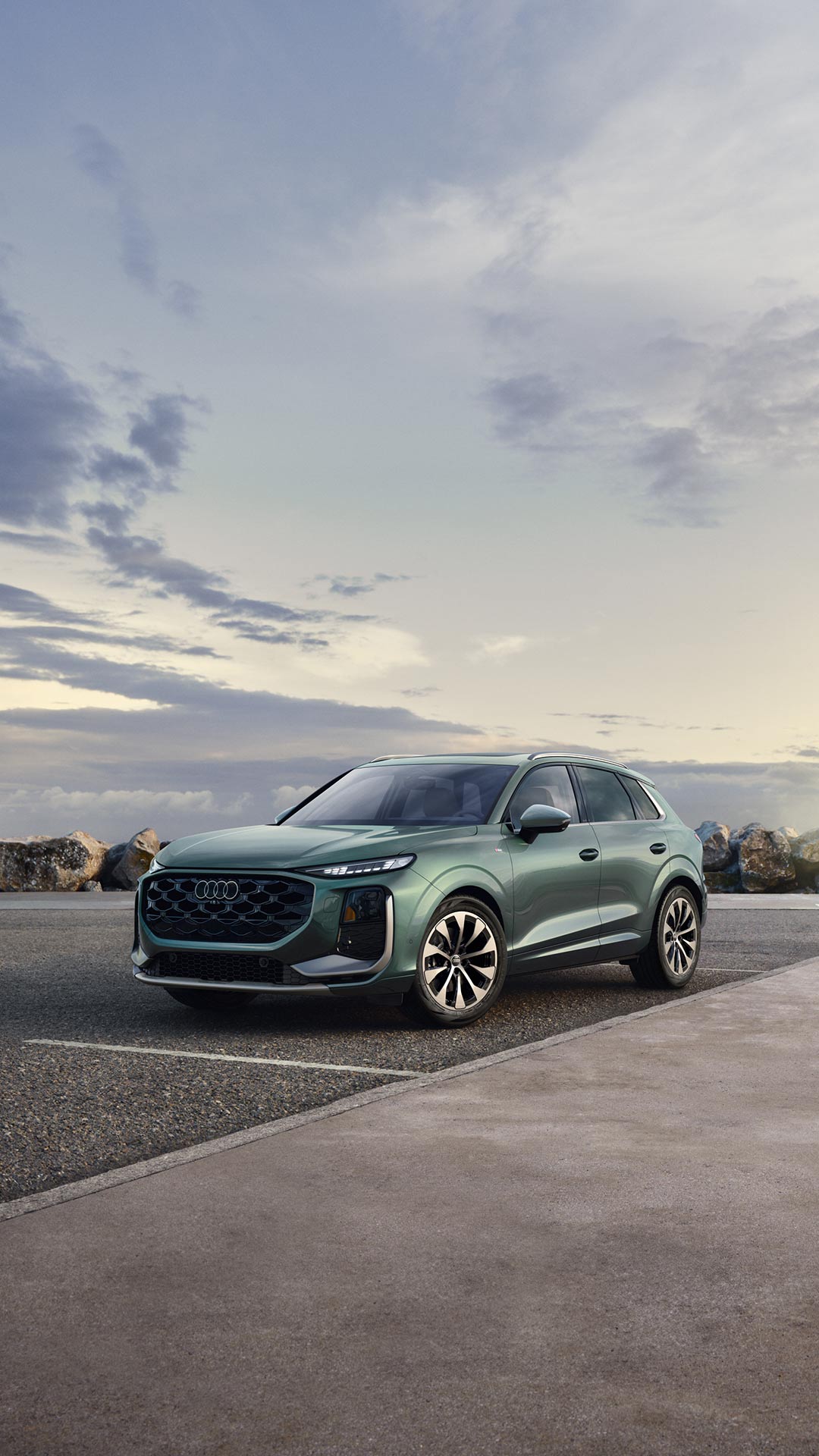 Three-quarter side profile of an Audi A6 accelerating.