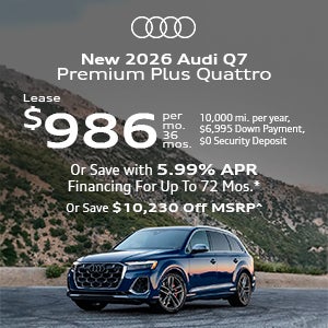 Side view of an Audi Q7 driving.