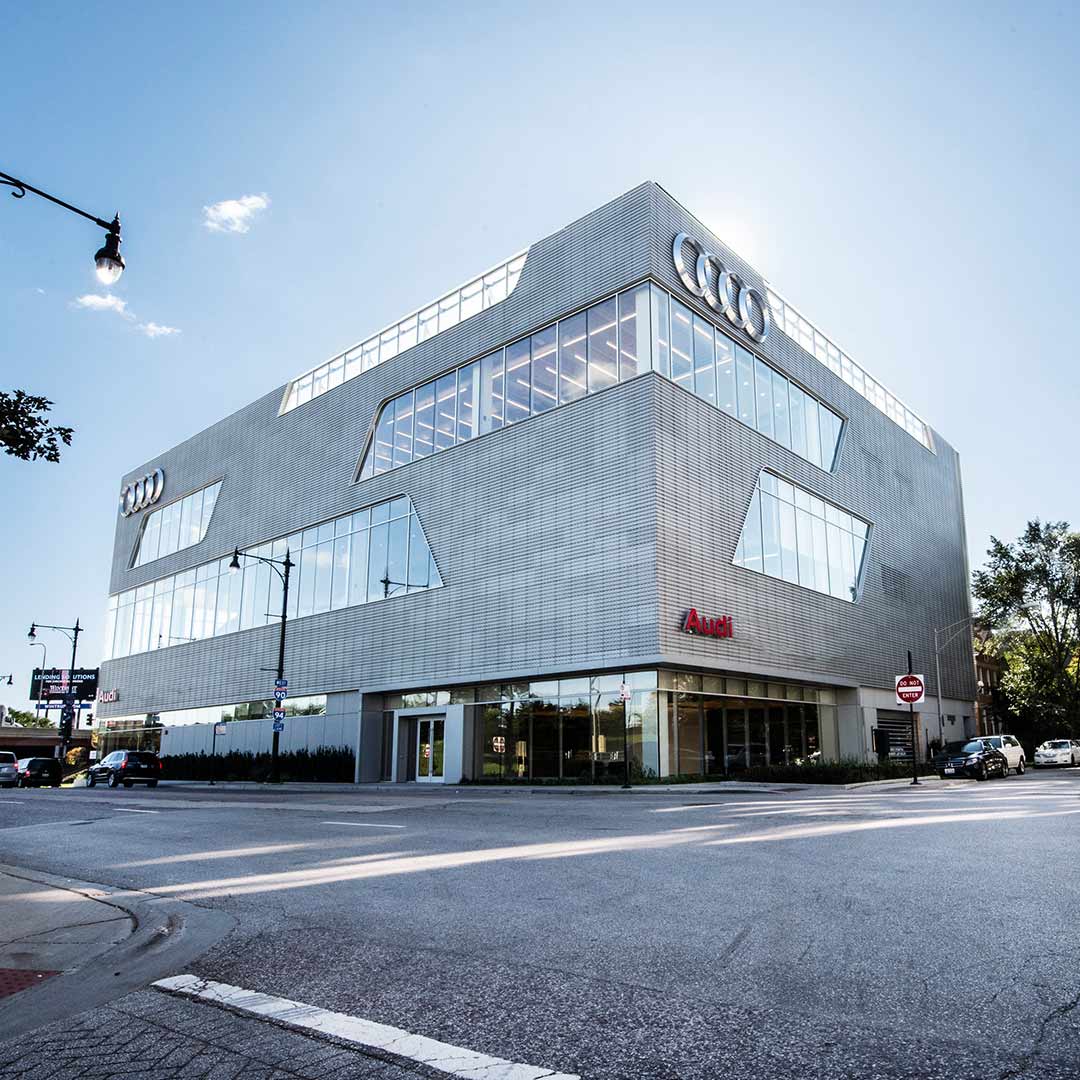 Audi Sale Specialist walking through the showroom with a couple.
