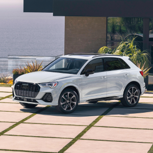 Side view of an Audi Q3 driving.