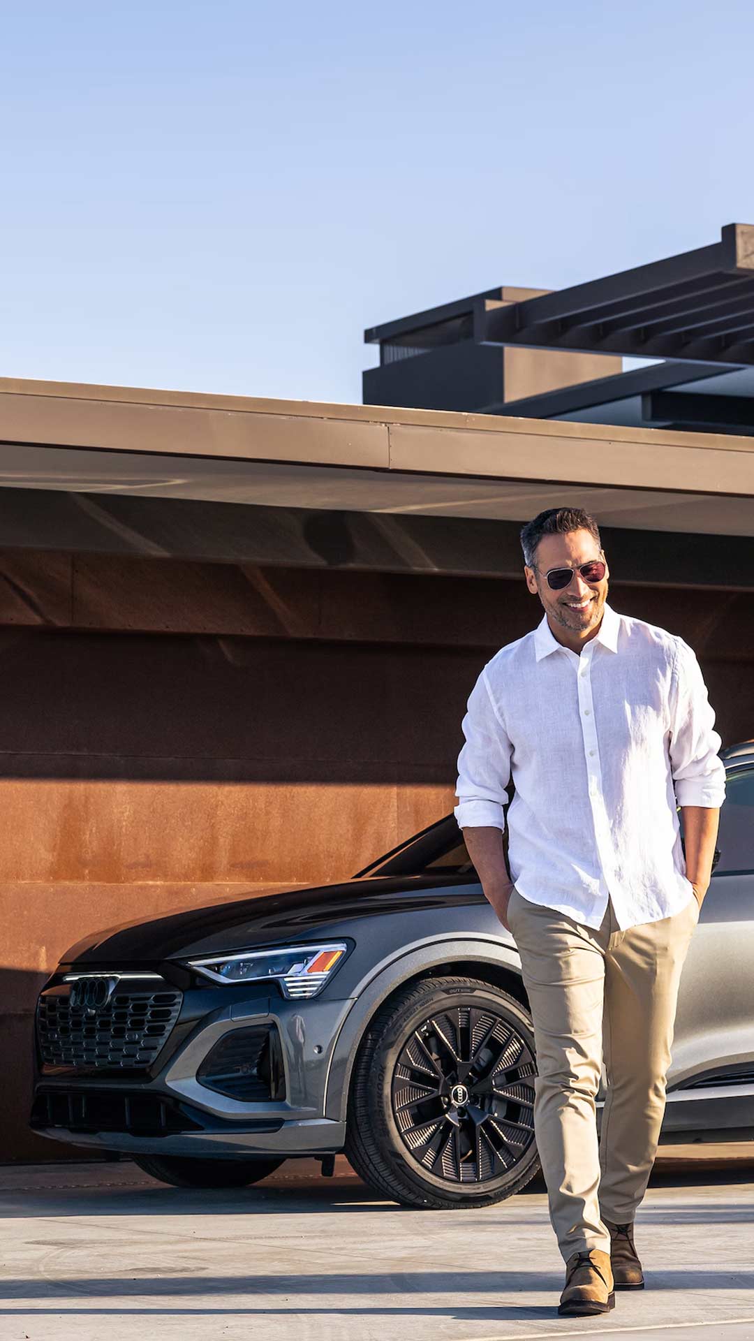 Man walking away from Audi in driveway