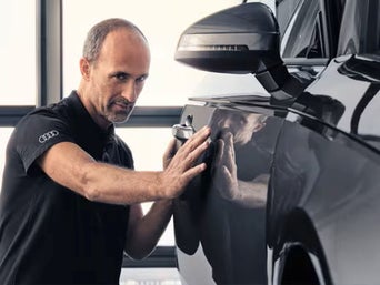 Service technician serving vehicle.