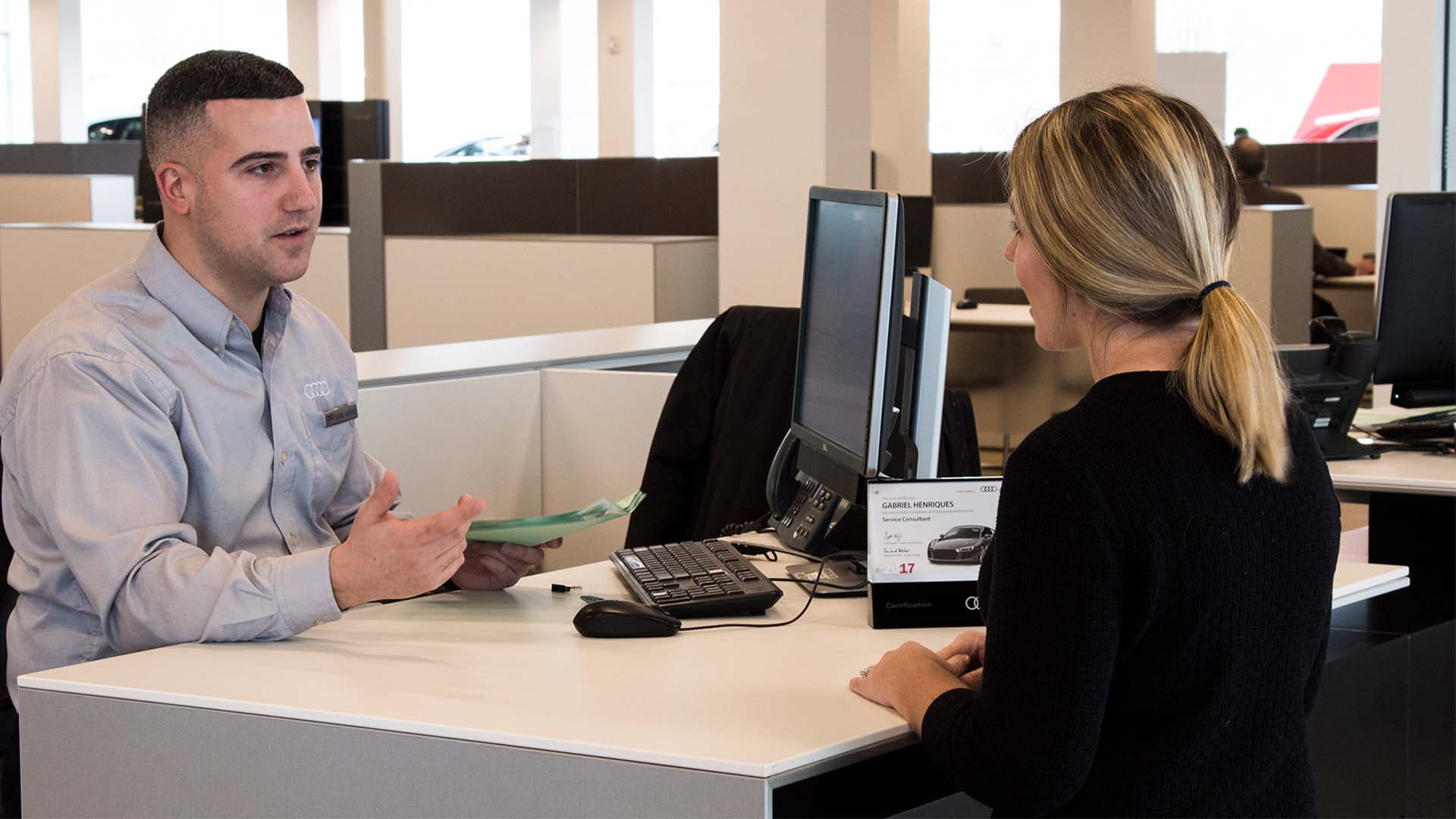Audi service technician servicing a vehicle.