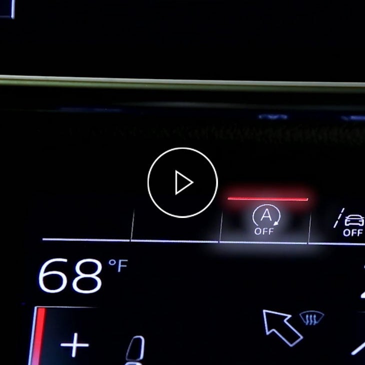 Close-up on the dashboard of an Audi displaying the start, stop switch.